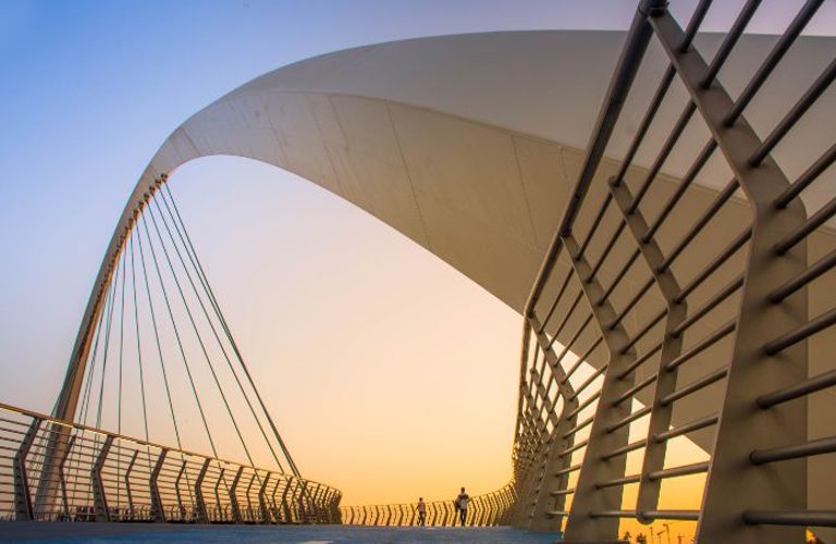 Lenvi image of a bridge at sunrise with metal railings