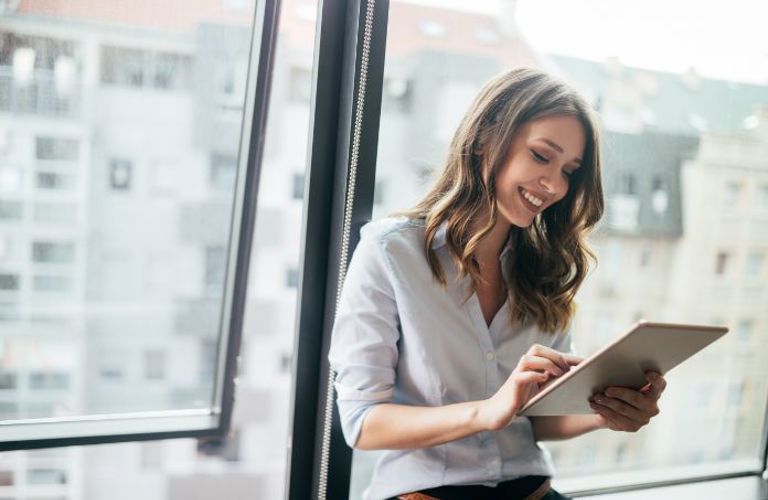 Lenvi image of a woman on a tablet in an office environment