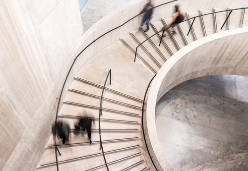 Image of people going down spiral stairs